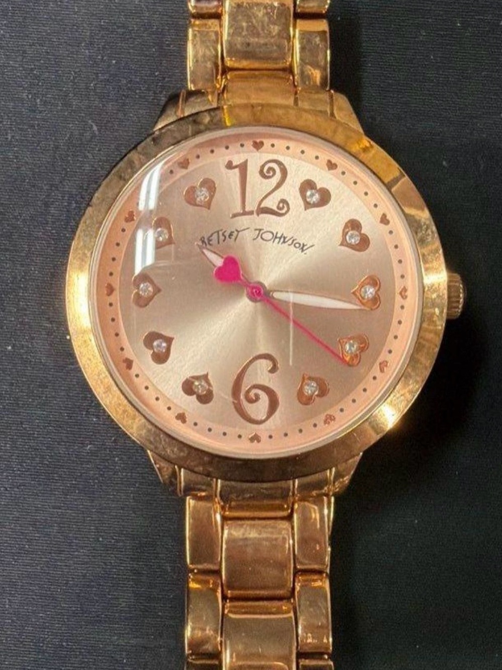 Betsey Johnson women's fashion watch w/a pink-hued sunburst dial, crystal hours